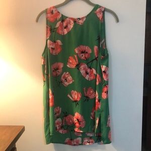 Green floral sleeveless blouse.